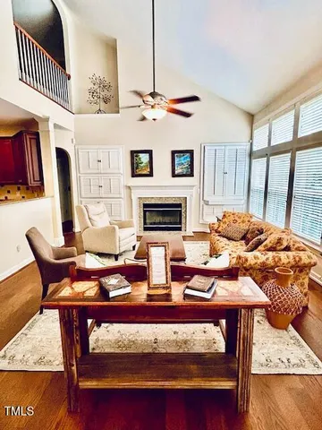 a view of an empty room with a fireplace and a window