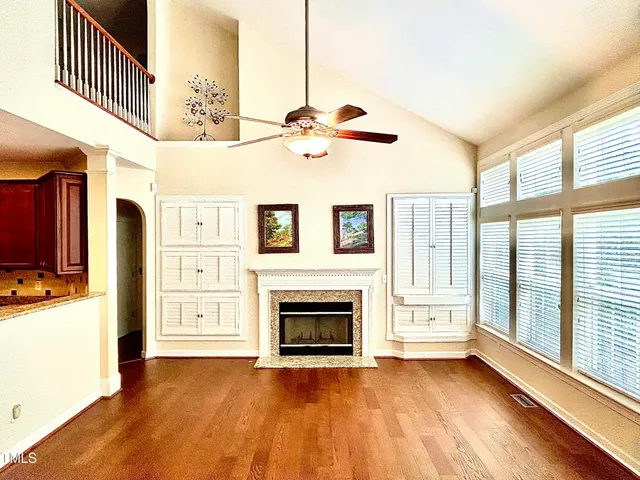 a kitchen with stainless steel appliances granite countertop wooden cabinets and a refrigerator