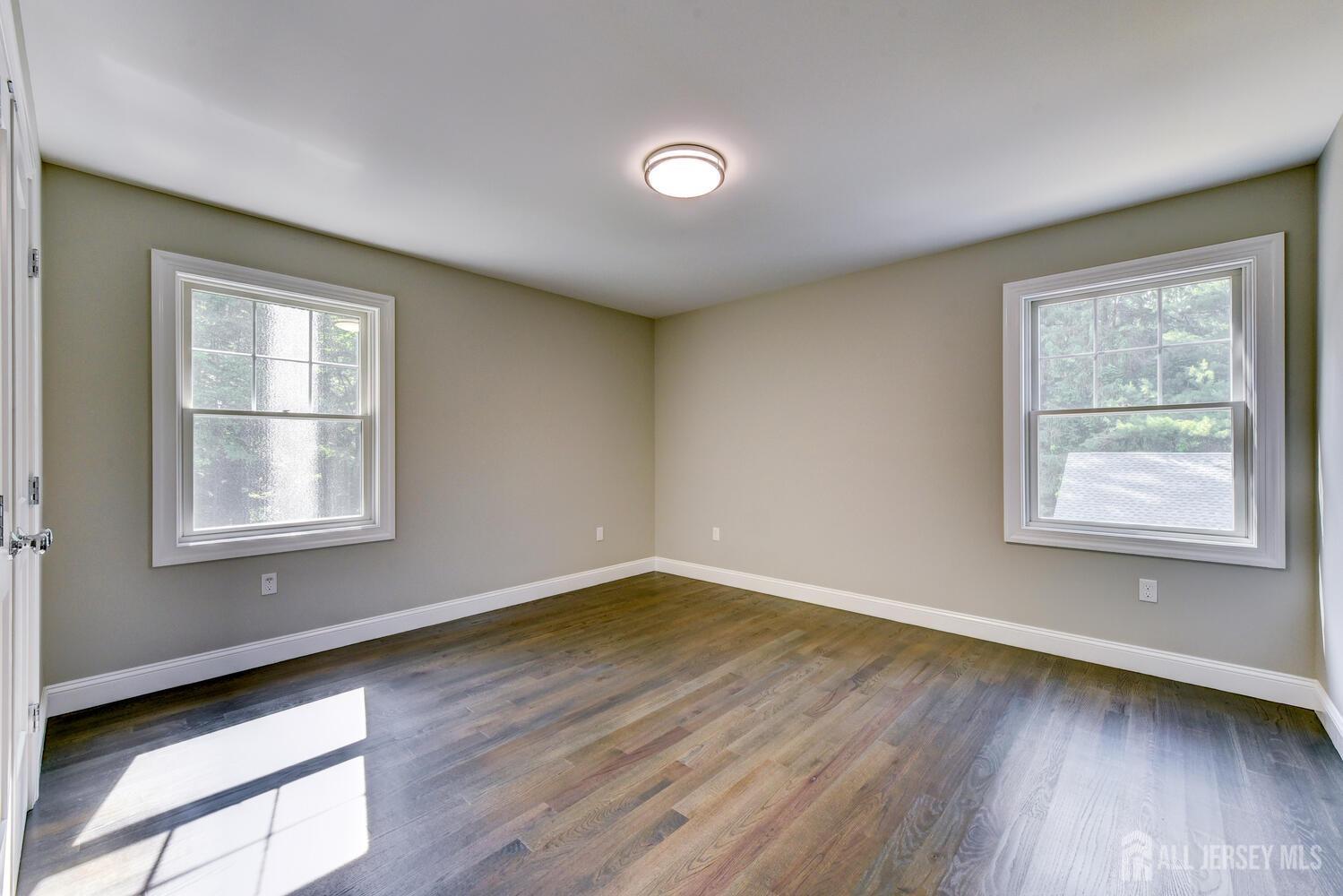 923 Iron Bridge Road Asbury, NJ 08802 - Photo 12 of 41 a view of an empty room with wooden floor and a window