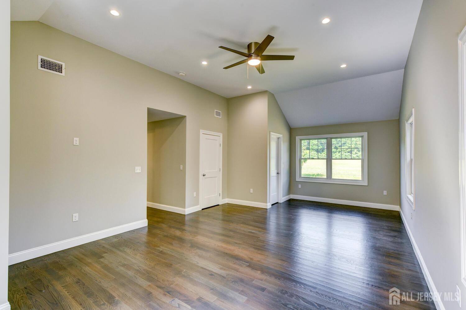 923 Iron Bridge Road Asbury, NJ 08802 - Photo 16 of 41 a view of an empty room with wooden floor and a window