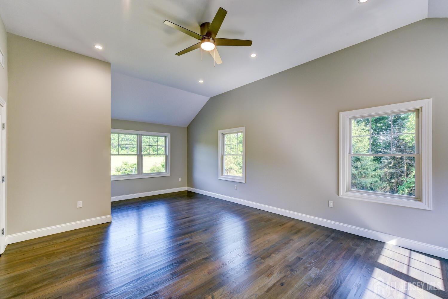 923 Iron Bridge Road Asbury, NJ 08802 - Photo 17 of 41 an empty room with wooden floor and windows