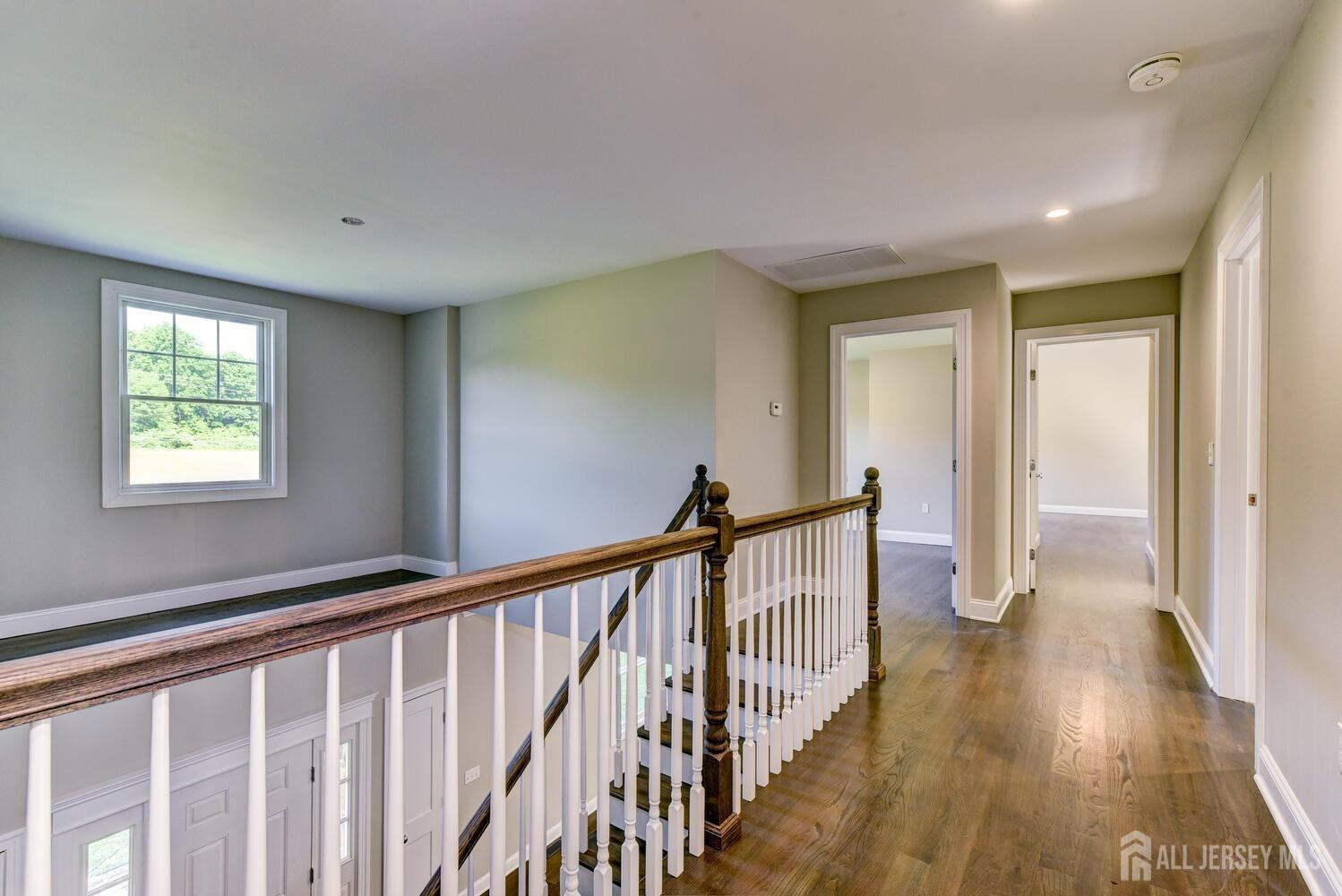923 Iron Bridge Road Asbury, NJ 08802 - Photo 19 of 41 a view of a hallway with wooden floor and windows