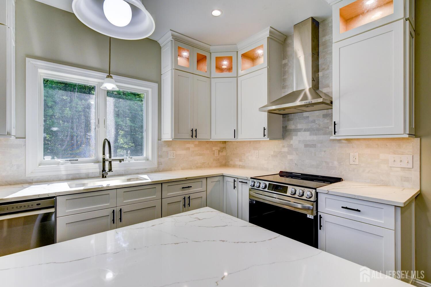 923 Iron Bridge Road Asbury, NJ 08802 - Photo 24 of 41 a kitchen with stainless steel appliances granite countertop a sink stove and cabinets