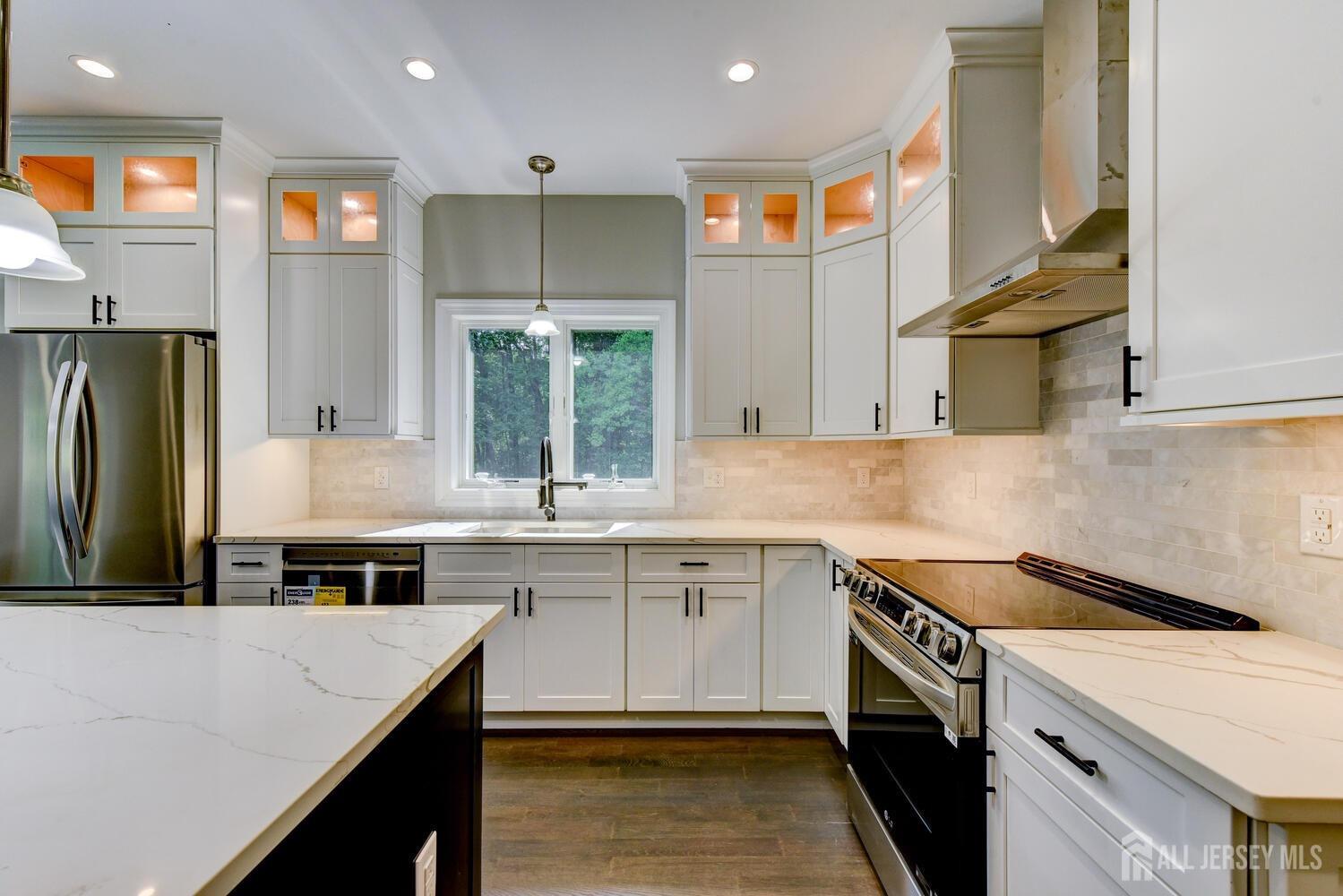 923 Iron Bridge Road Asbury, NJ 08802 - Photo 26 of 41 a kitchen with a sink a stove and cabinets
