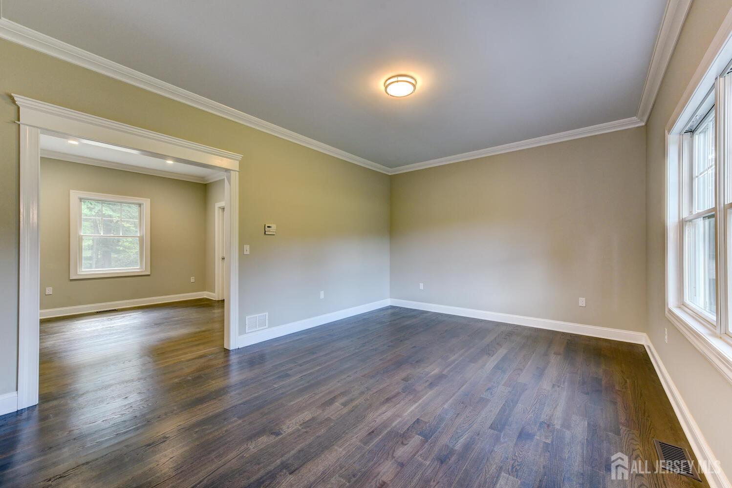 923 Iron Bridge Road Asbury, NJ 08802 - Photo 38 of 41 a view of an empty room with wooden floor and a window