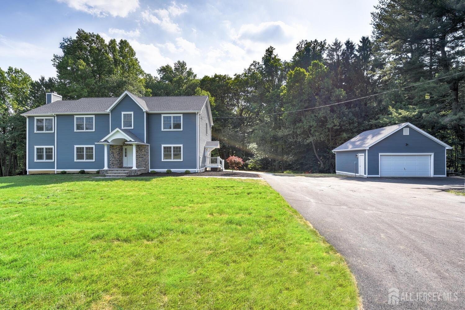 923 Iron Bridge Road Asbury, NJ 08802 - Photo 41 of 41 a front view of a house with a garden and yard