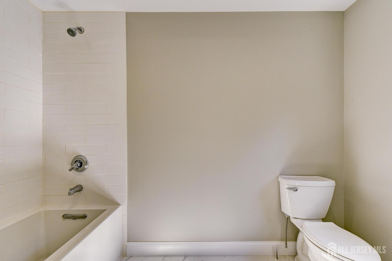 923 Iron Bridge Road Asbury, NJ 08802 - Photo 10 of 41 a bathroom with a toilet and a bathtub