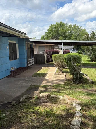 a view of a patio with a table chairs potted plants with wooden fence