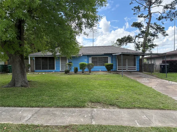 a front view of a house with a yard table and chairs