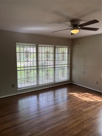 a view of room with wooden floor and fan