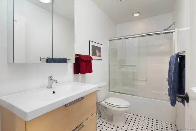 a bathroom with a sink toilet and shower
