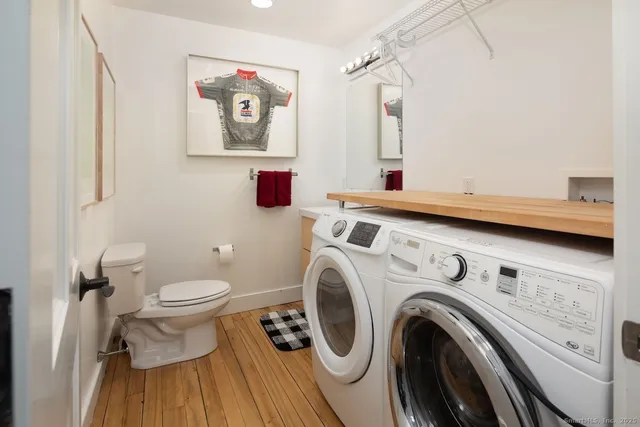 a view of a bathroom with washing machine and a view of a house