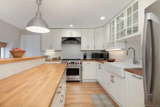a kitchen with stainless steel appliances granite countertop a sink and cabinets