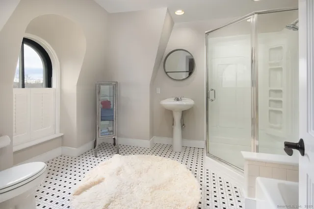 a bathroom with a sink toilet and shower