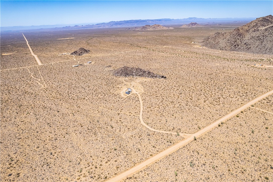 16435 South Wyatt Earp Road Yucca, AZ 86438 - Photo 45 of 57 Expansive desert landscape featuring natural rock formations and a distant mountain range