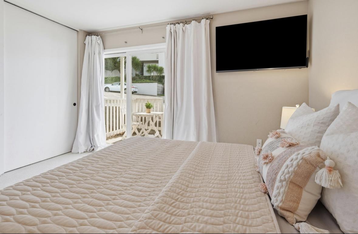 229 Rio Del Mar Boulevard Aptos, CA 95003 - Photo 13 of 27 a bedroom with a bed and a flat screen tv