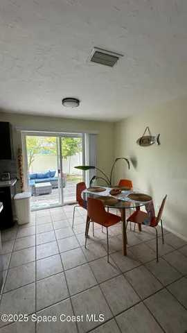 a living room with furniture a flat screen tv and a window
