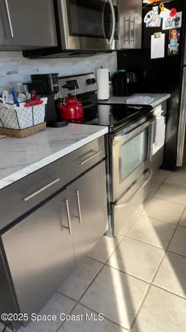 a kitchen with stainless steel appliances granite countertop a sink and cabinets