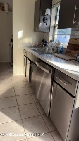 a kitchen with a sink a stove and cabinets