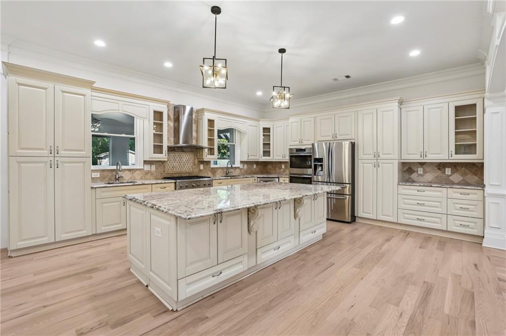 3170 Lavista Road Decatur, GA 30033 - Photo 12 of 29 a kitchen with stainless steel appliances kitchen island granite countertop a stove a sink and a refrigerator