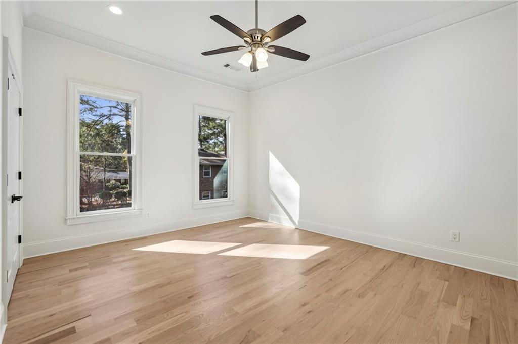 3170 Lavista Road Decatur, GA 30033 - Photo 18 of 29 an empty room with wooden floor and windows