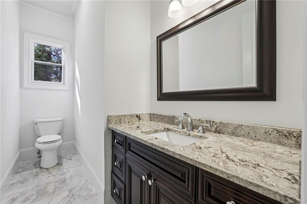 3170 Lavista Road Decatur, GA 30033 - Photo 19 of 29 a bathroom with a granite countertop sink a toilet and mirror