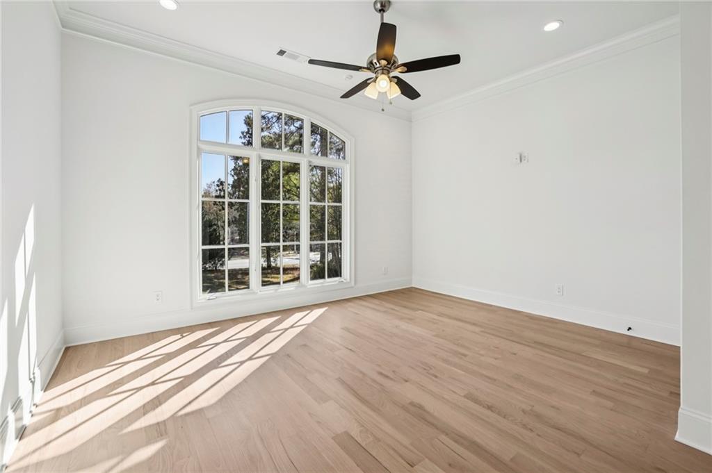 3170 Lavista Road Decatur, GA 30033 - Photo 20 of 29 an empty room with wooden floor fan and windows