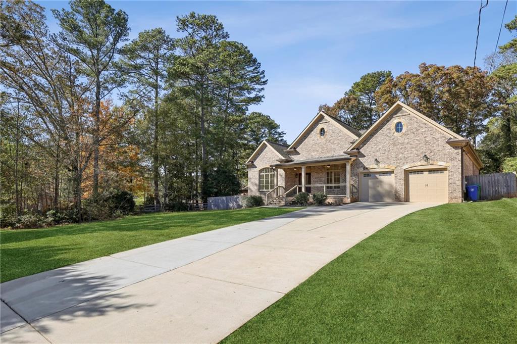 3170 Lavista Road Decatur, GA 30033 - Photo 3 of 29 a front view of a house with a garden and trees