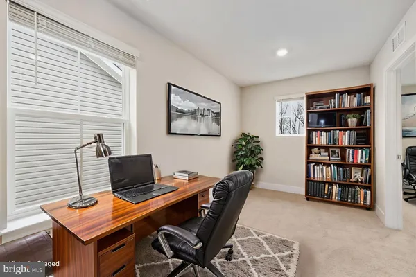 a view of a workspace with furniture and a potted plant