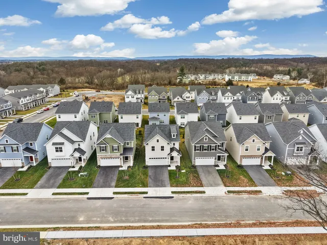 an aerial view of residential houses with city view