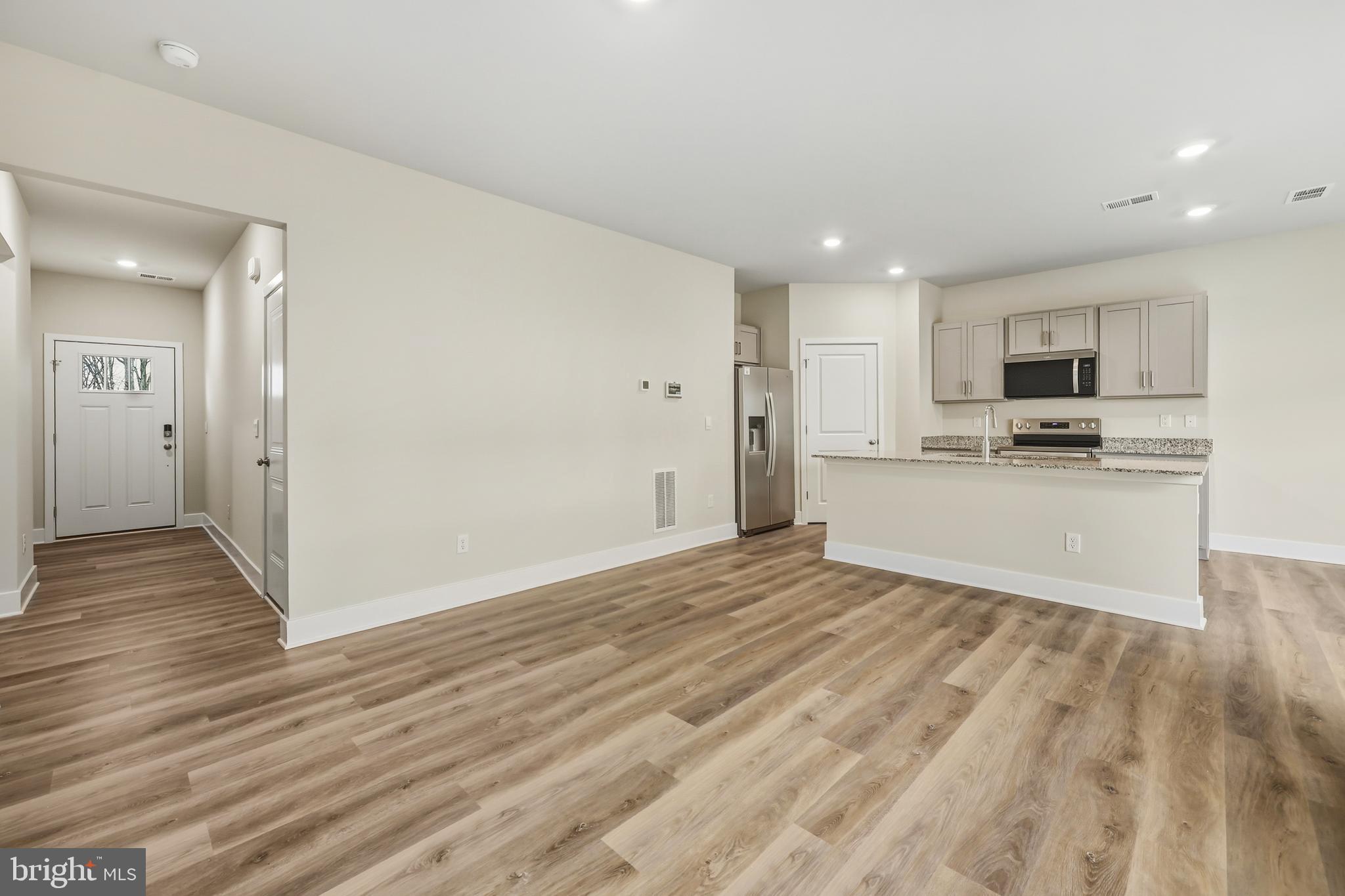 226 Munsee Winchester, VA 22603 - Photo 5 of 33 a view of a kitchen with wooden floor and a sink