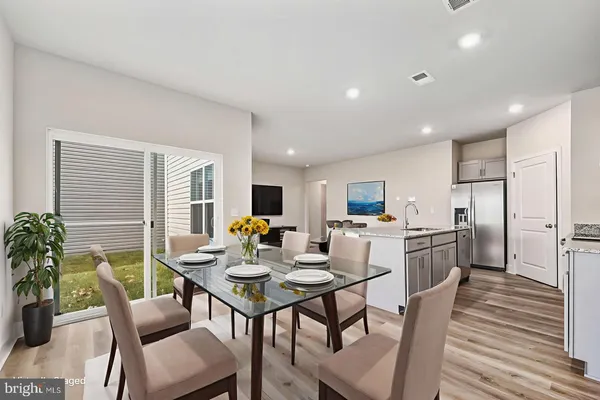 a kitchen and a dining room with furniture