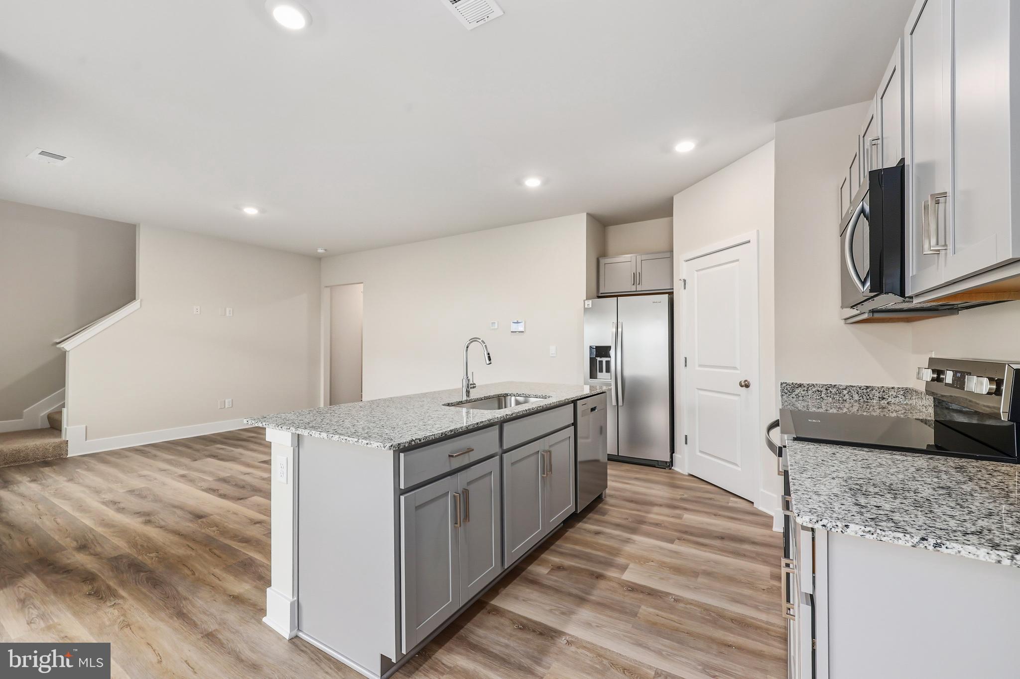 226 Munsee Winchester, VA 22603 - Photo 9 of 33 a kitchen with stainless steel appliances granite countertop a sink stove and refrigerator
