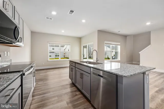 a large kitchen with granite countertop lots of counter top space
