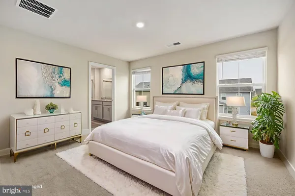 a spacious bedroom with a bed and a window