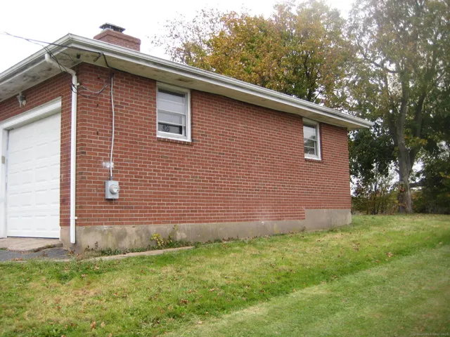 a side view of a house with a yard