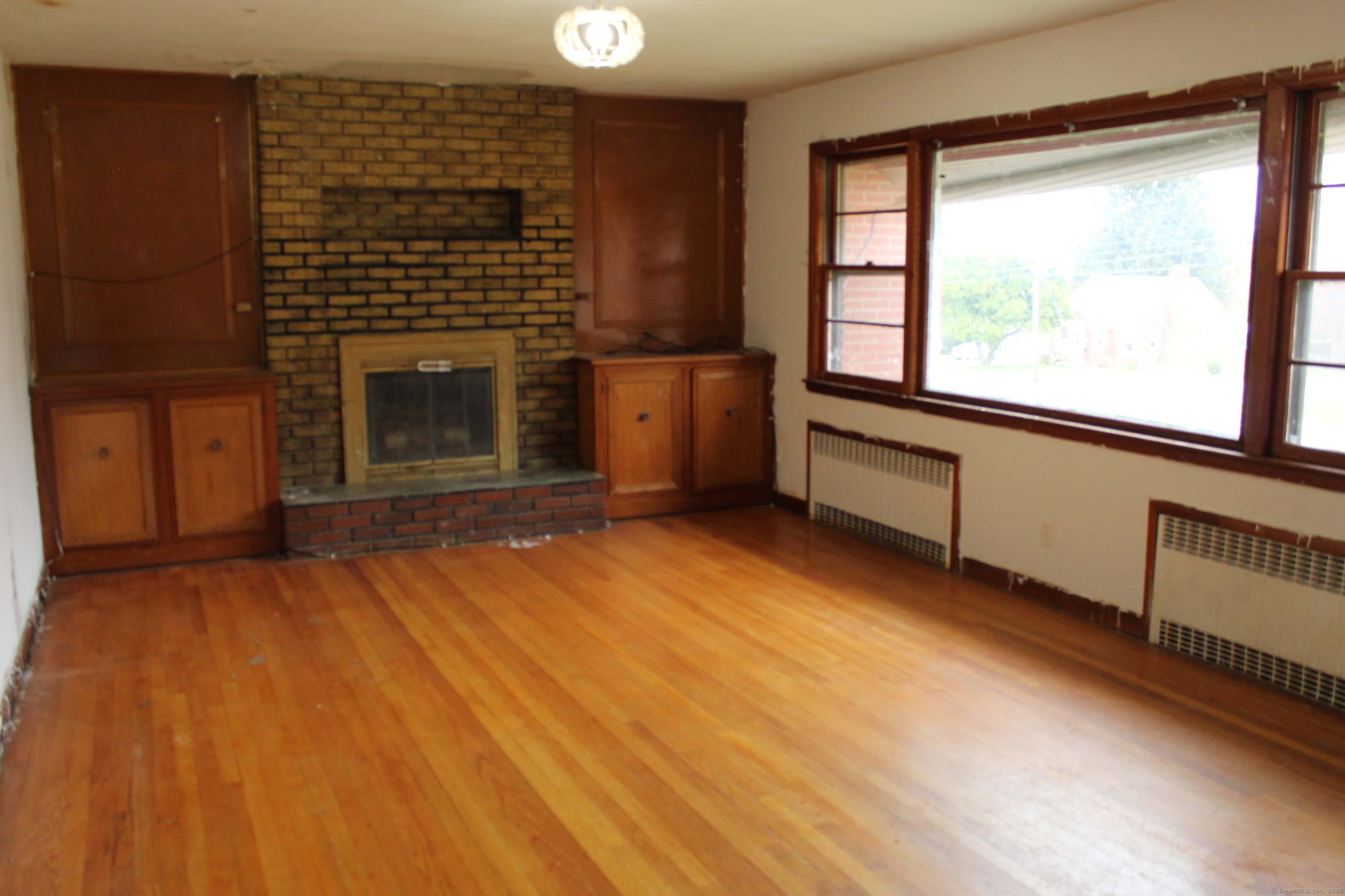 347 Farm Hill Road Middletown, CT 06457 - Photo 5 of 15 a view of an empty room with a fireplace and a window