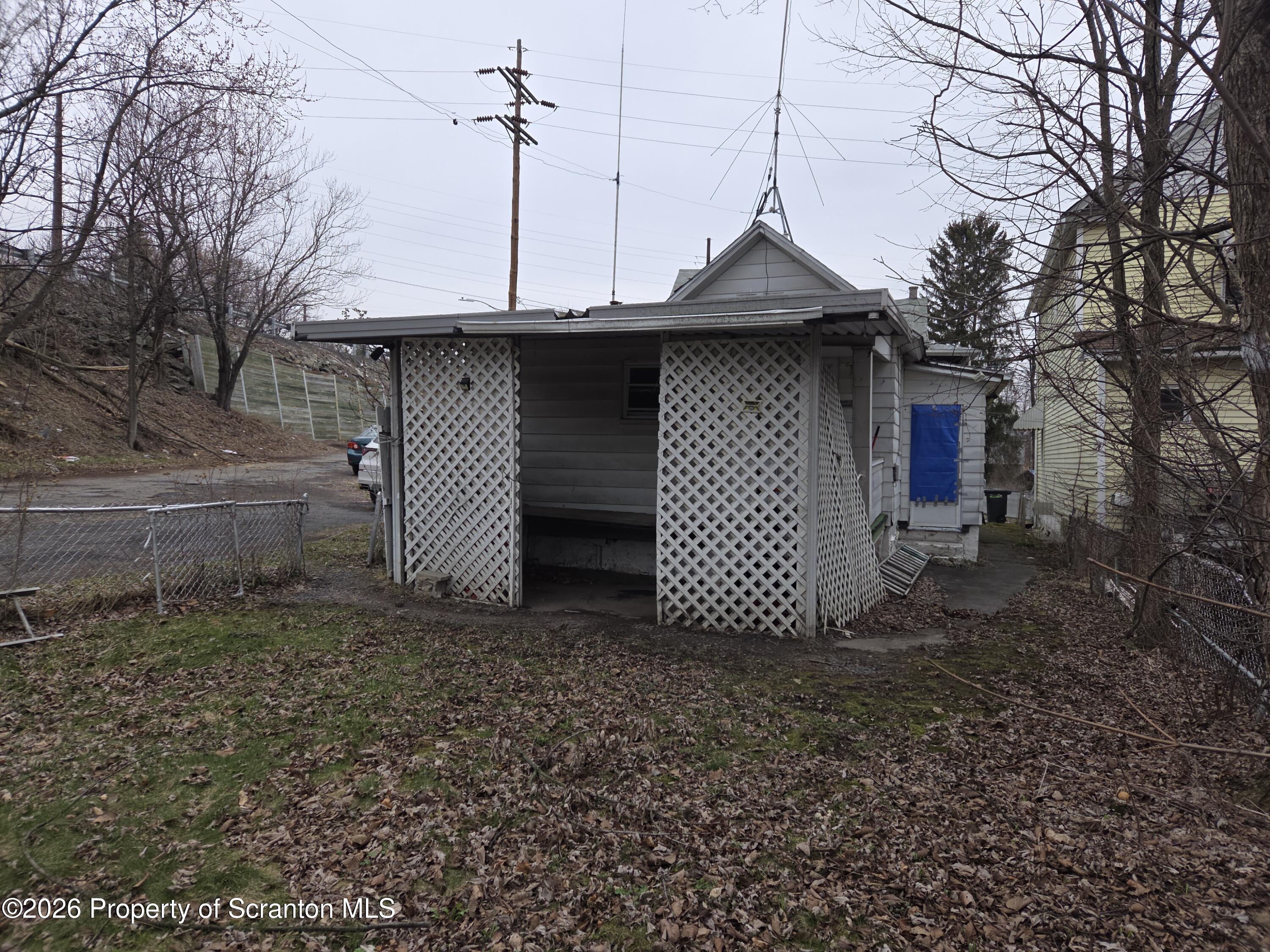 521 Albion Street Scranton, PA 18508 - Photo 5 of 22 a small barn with a small yard and a large tree