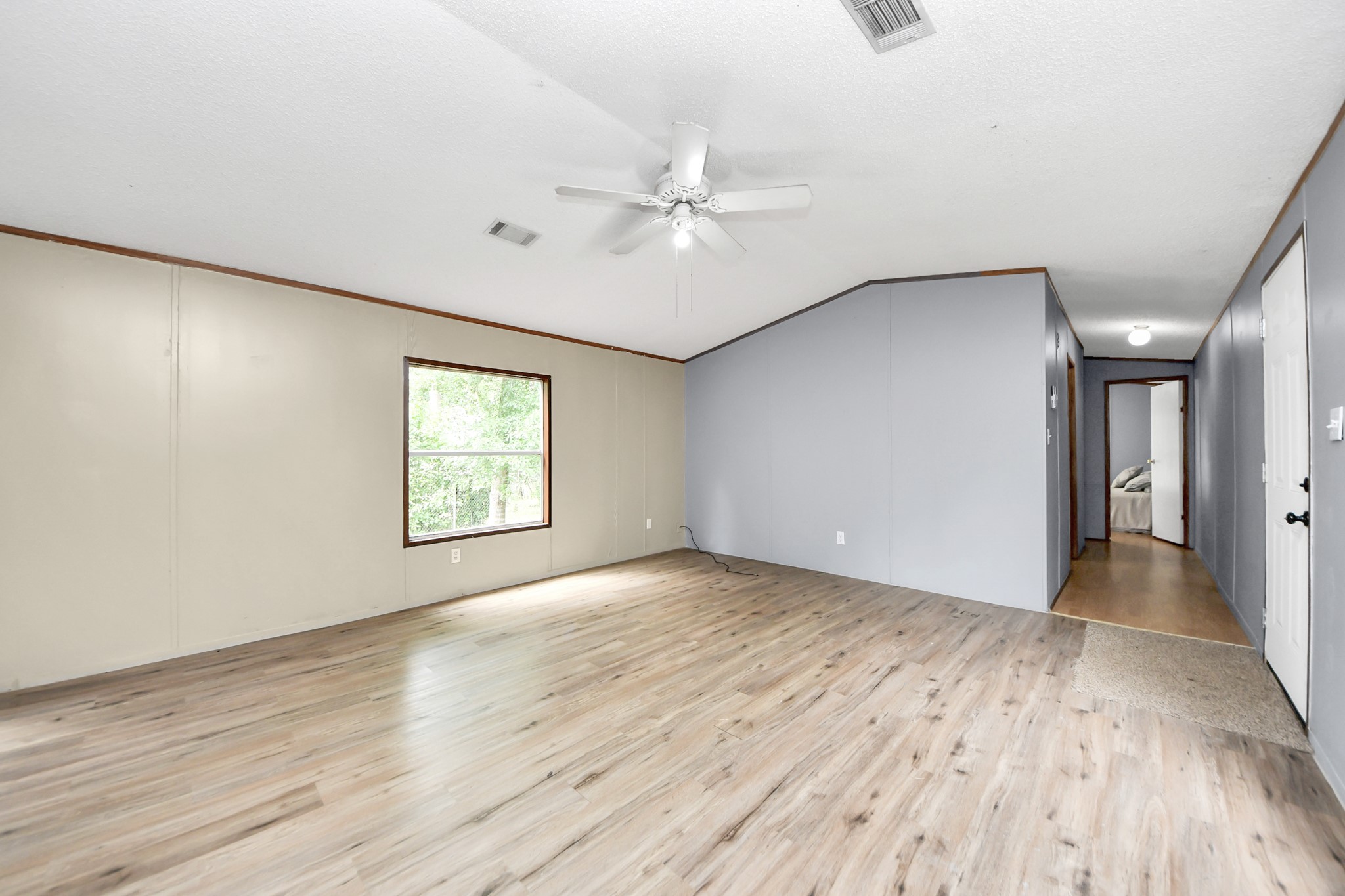 25932 Thatcham New Caney, TX 77357 - Photo 13 of 44 wooden floor in an empty room with a window