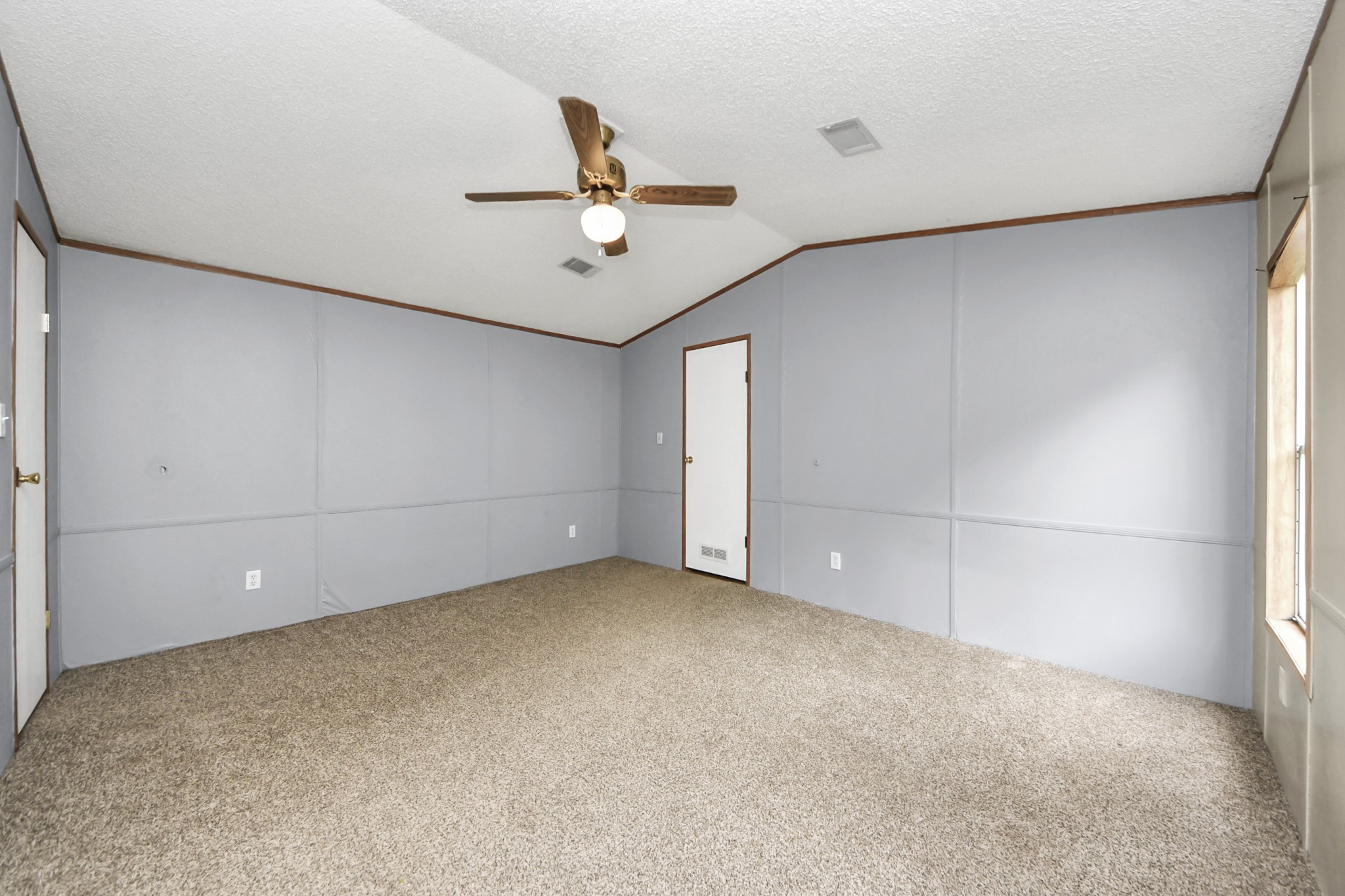 25932 Thatcham New Caney, TX 77357 - Photo 15 of 44 an empty room with a ceiling fan and carpet