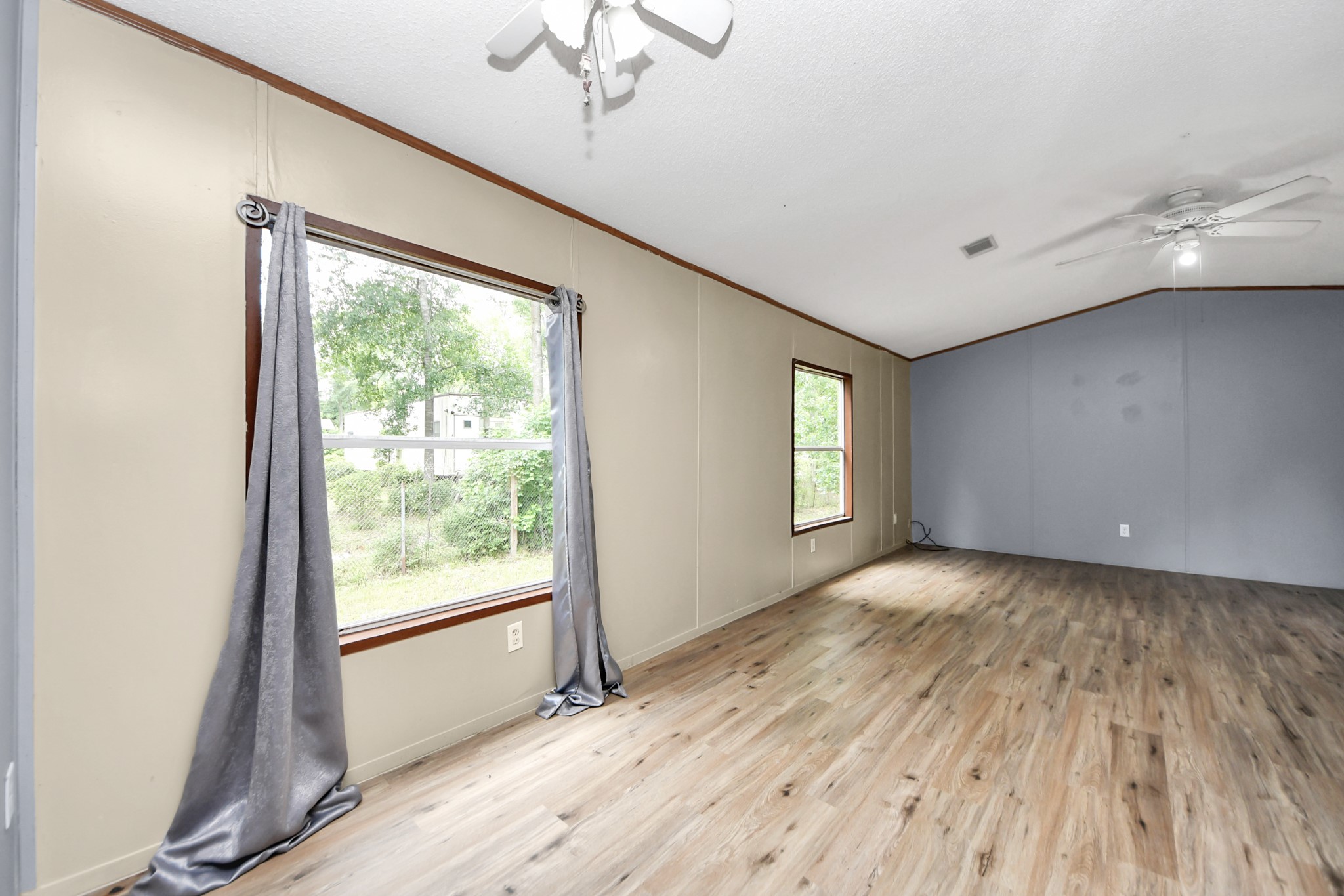 25932 Thatcham New Caney, TX 77357 - Photo 20 of 44 a view of an empty room with wooden floor and a window