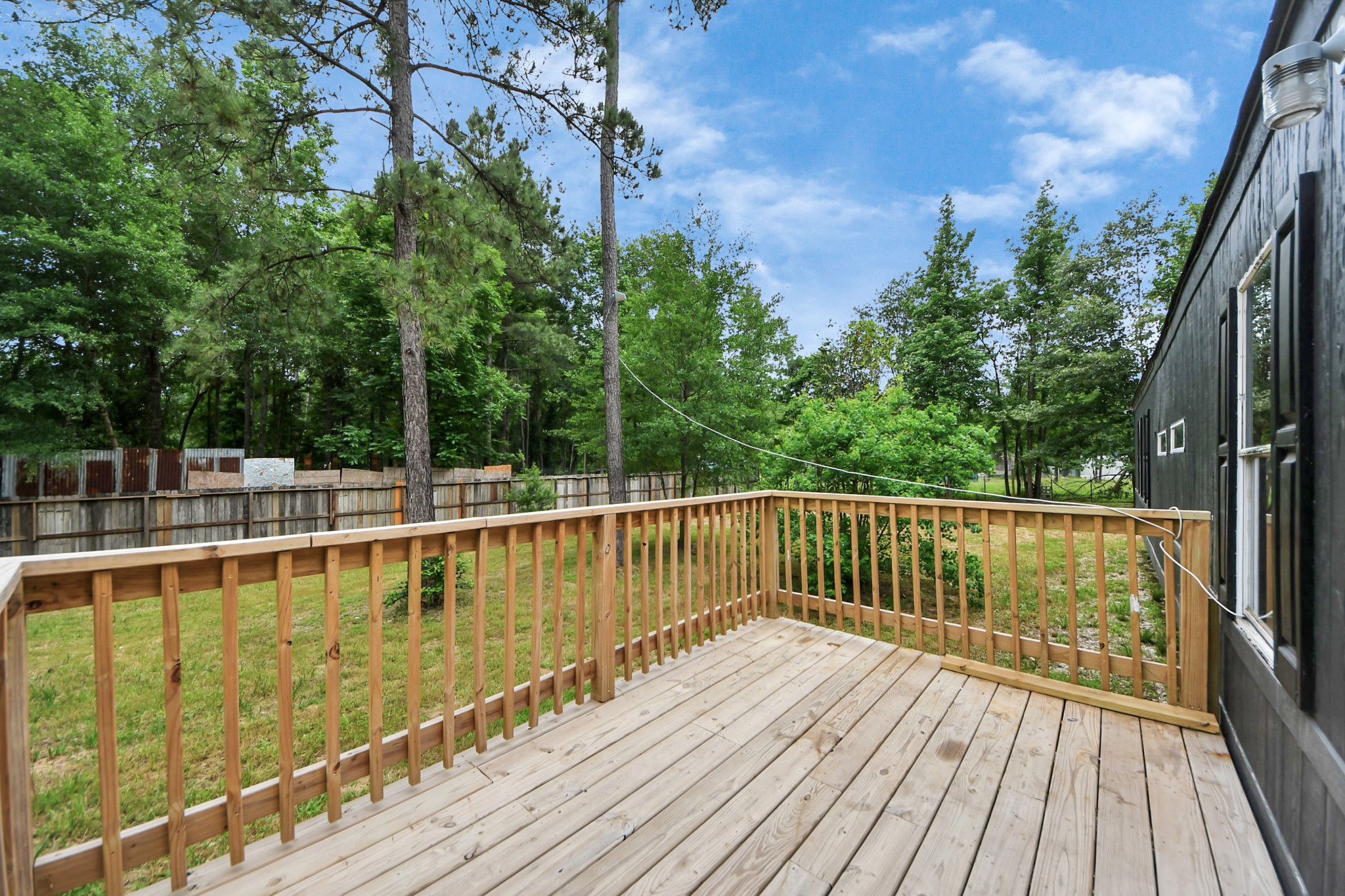 25932 Thatcham New Caney, TX 77357 - Photo 27 of 44 a view of a balcony with wooden floor and fence