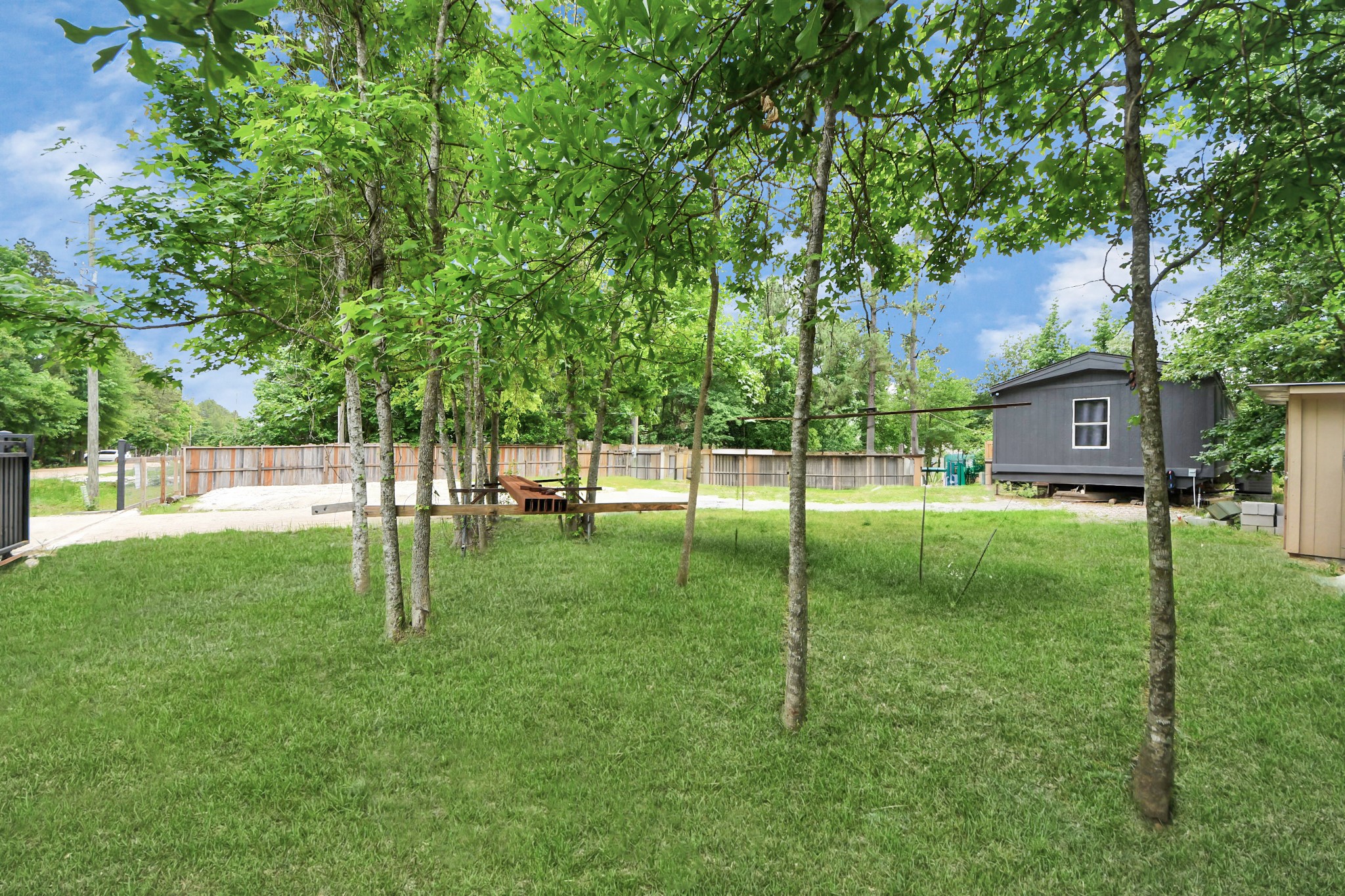 25932 Thatcham New Caney, TX 77357 - Photo 31 of 44 a view of a house with a backyard
