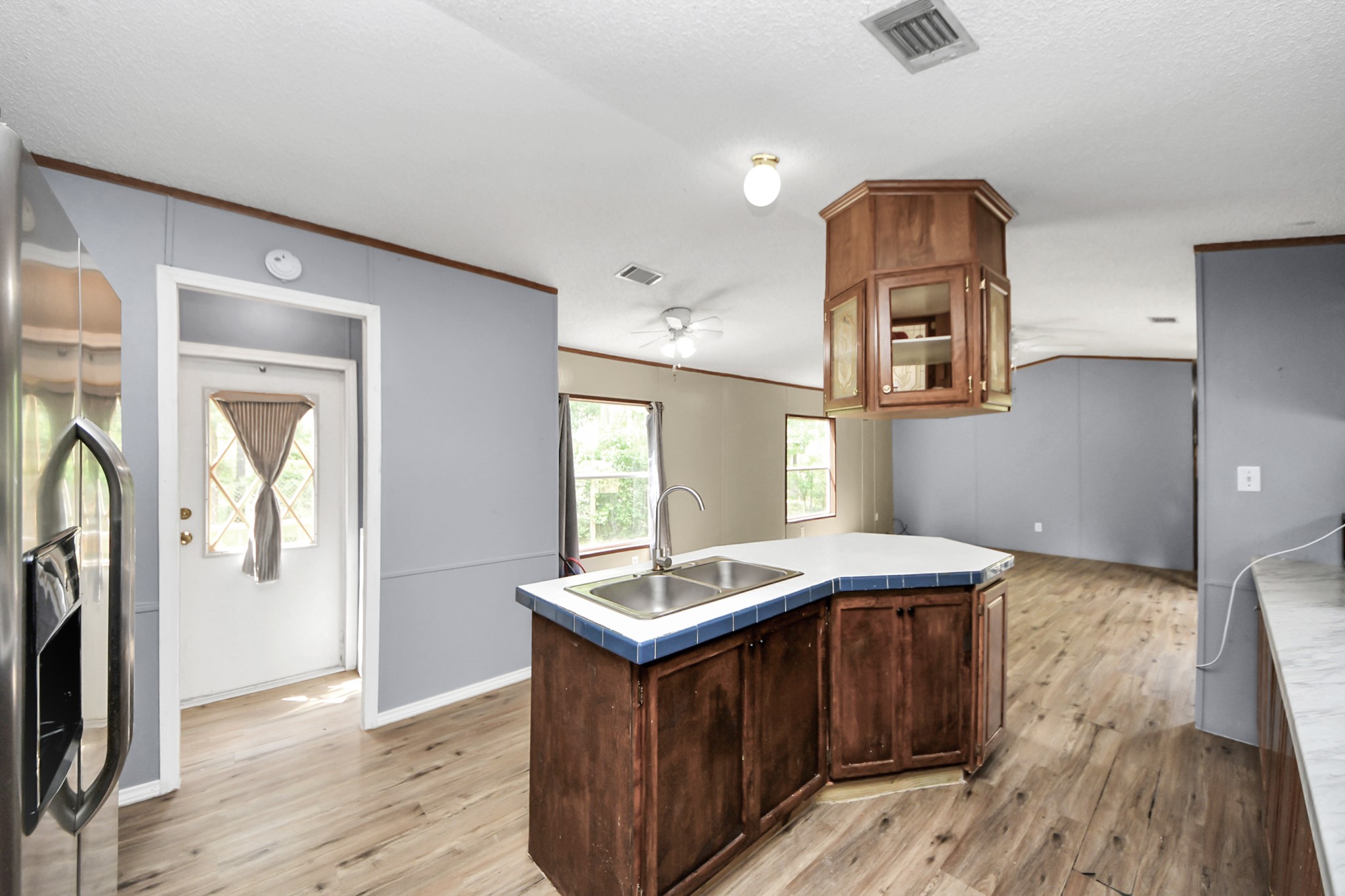 25932 Thatcham New Caney, TX 77357 - Photo 6 of 44 a kitchen with granite countertop a sink cabinets and wooden floor