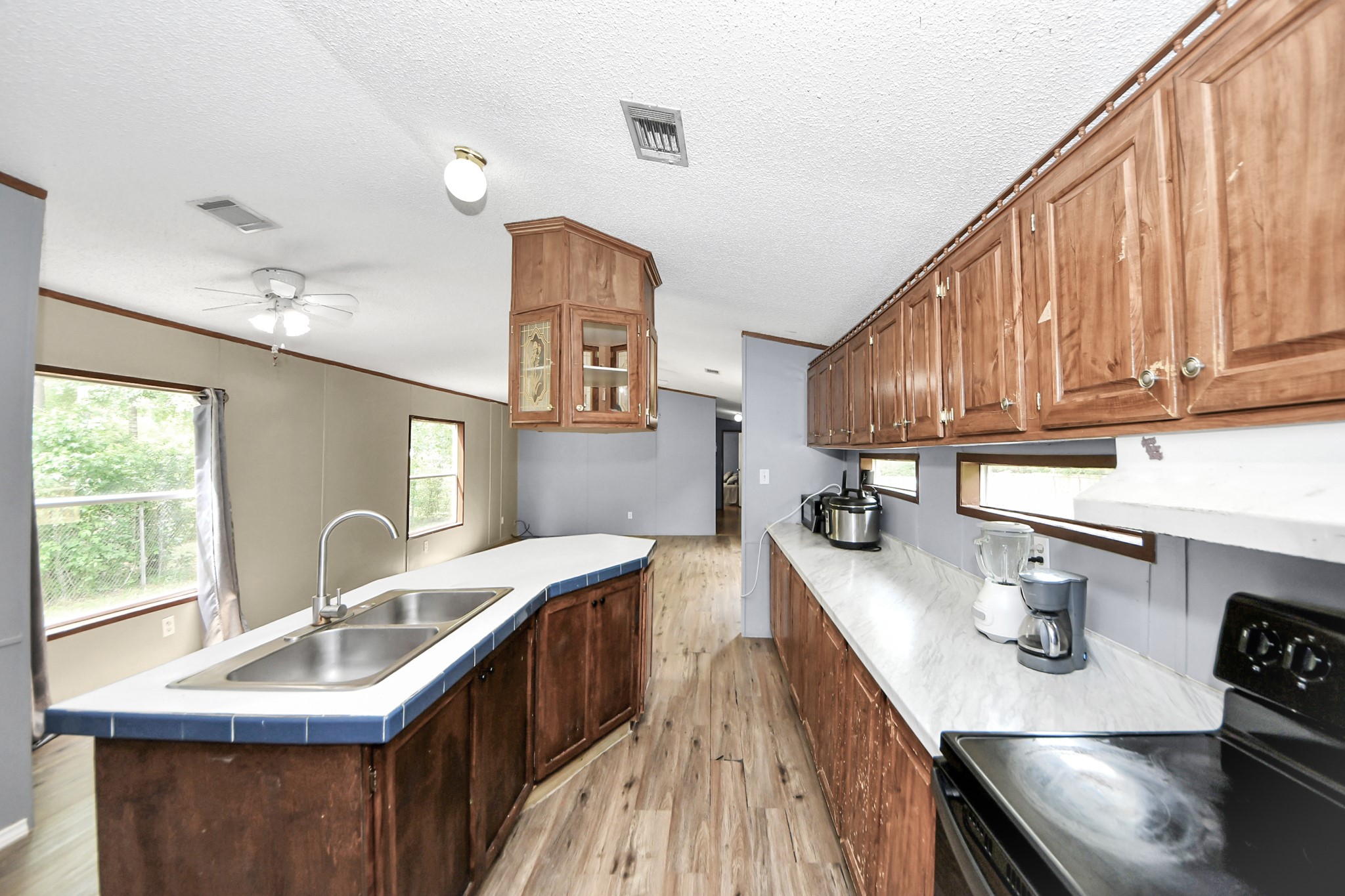 25932 Thatcham New Caney, TX 77357 - Photo 7 of 44 a kitchen with granite countertop a sink stove and cabinets
