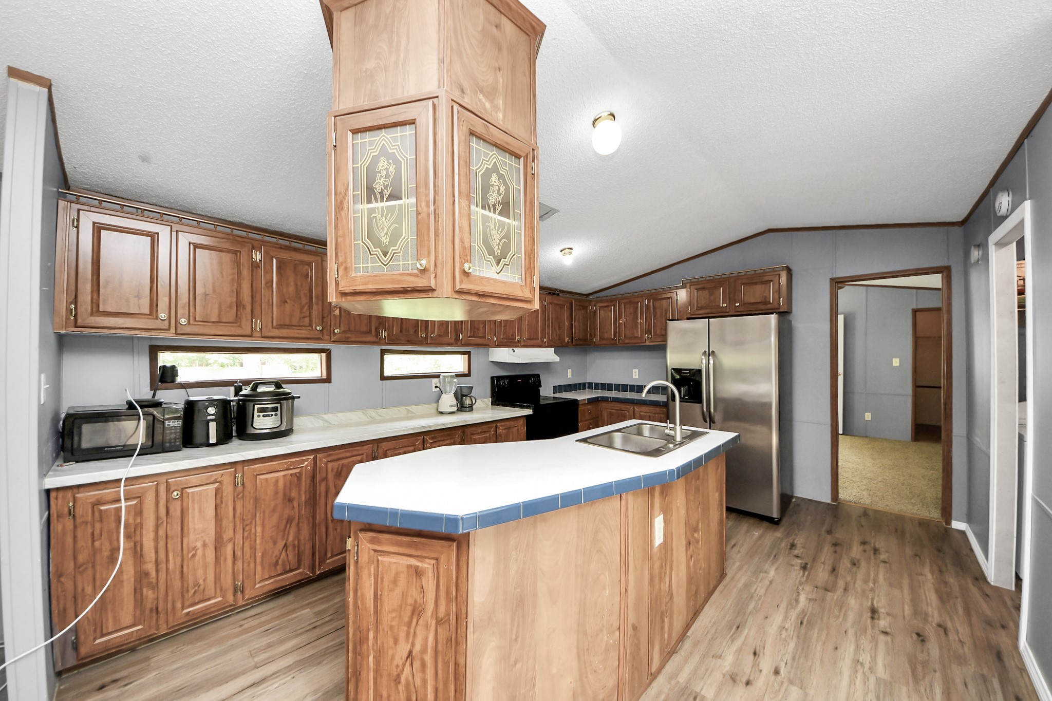 25932 Thatcham New Caney, TX 77357 - Photo 9 of 44 a kitchen with stainless steel appliances granite countertop a sink stove refrigerator and cabinets