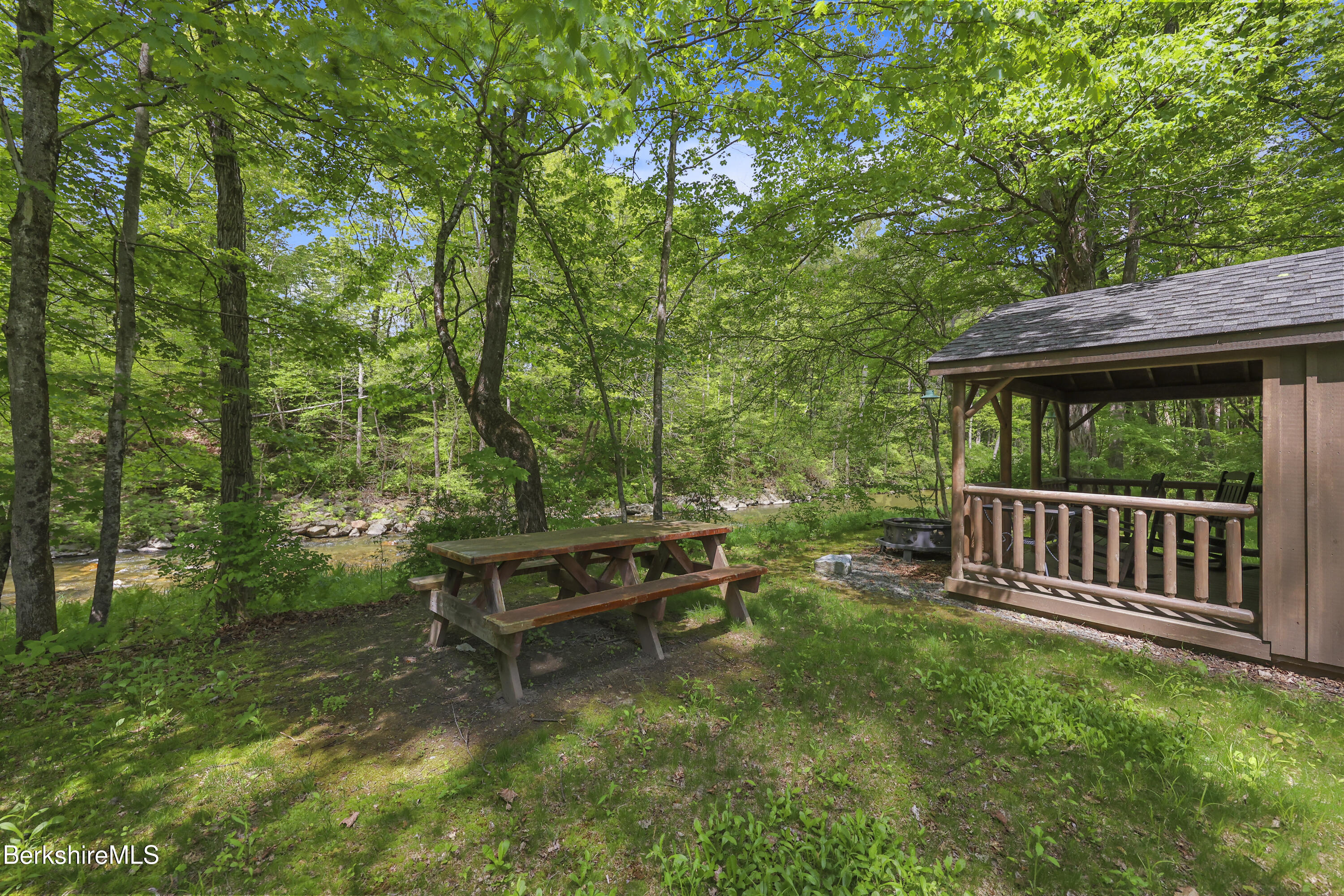 295 Blair Road Williamstown, MA 01267 - Photo 93 of 115 a view of a wooden deck with a bench and trees