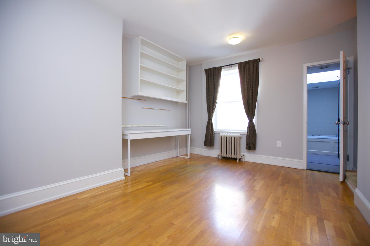 421 South 20th Street Philadelphia, PA 19146 - Photo 18 of 40 an empty room with wooden floor and window