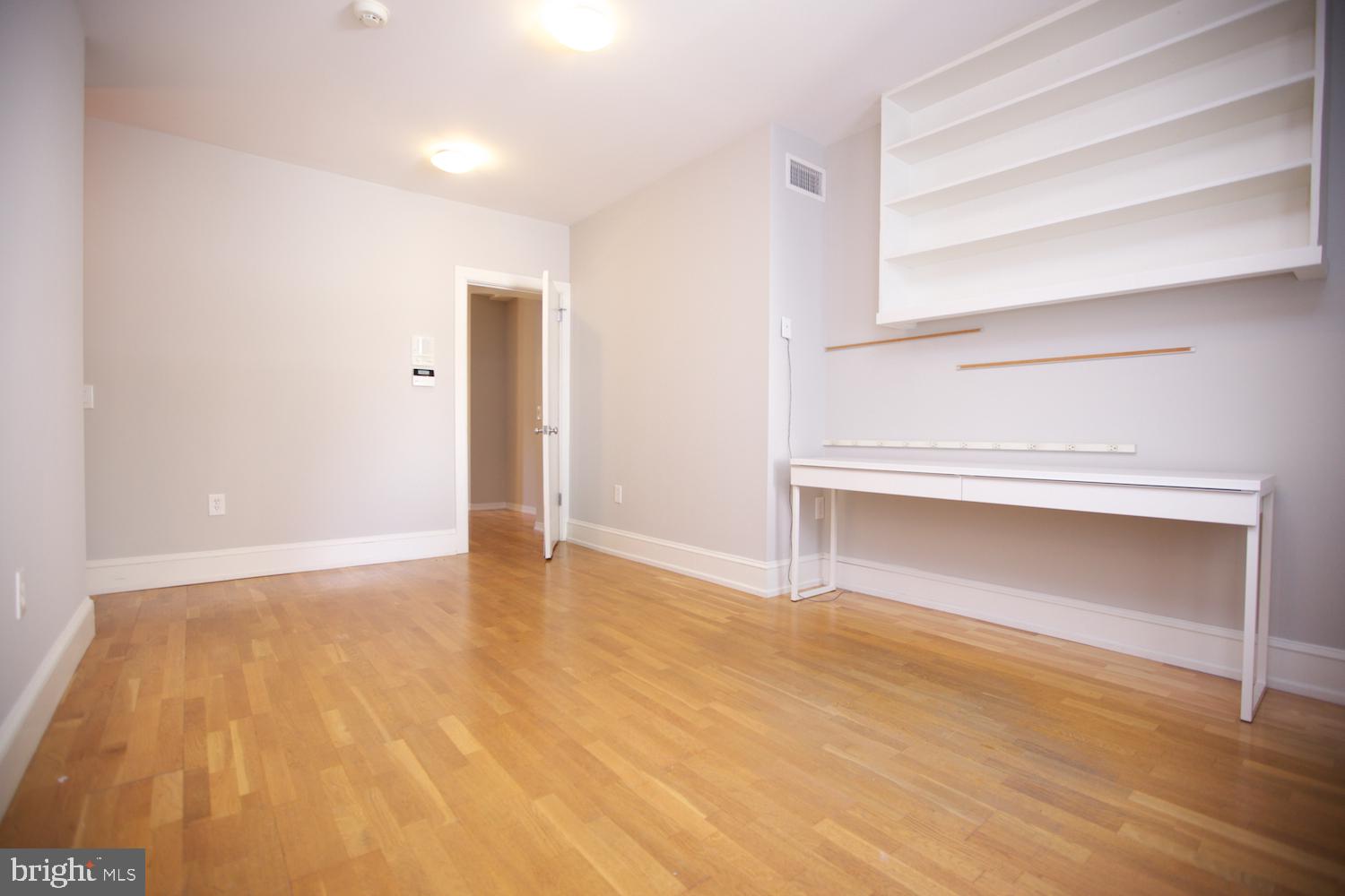 421 South 20th Street Philadelphia, PA 19146 - Photo 19 of 40 a view of an empty room with a fireplace and wooden floor