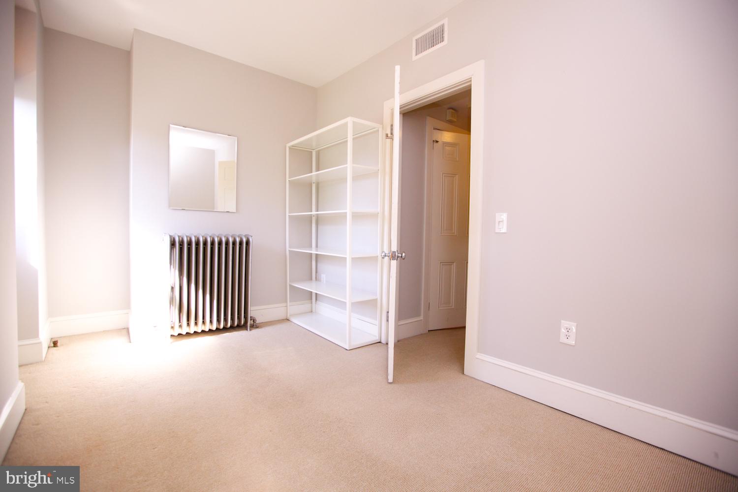 421 South 20th Street Philadelphia, PA 19146 - Photo 35 of 40 an empty room with a cabinet and mirrors